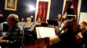 open rehearsal string ensemble with piano